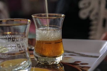 Glass of Moroccan Tea With Foamy Head