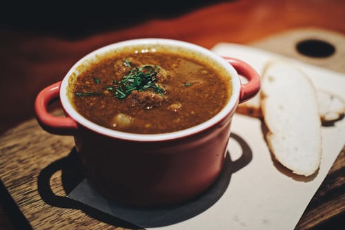 Brown Soup In Red Bowl