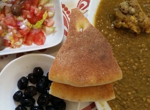 Moroccan Flat Bread Beside Black Olives Lentil Soup And Moroccan Salad